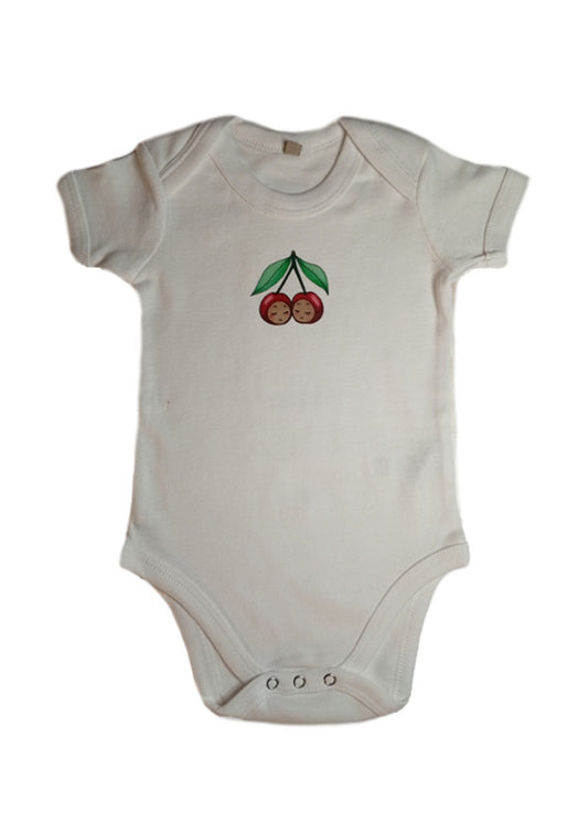 White baby onesie with cherry face print and snap closures