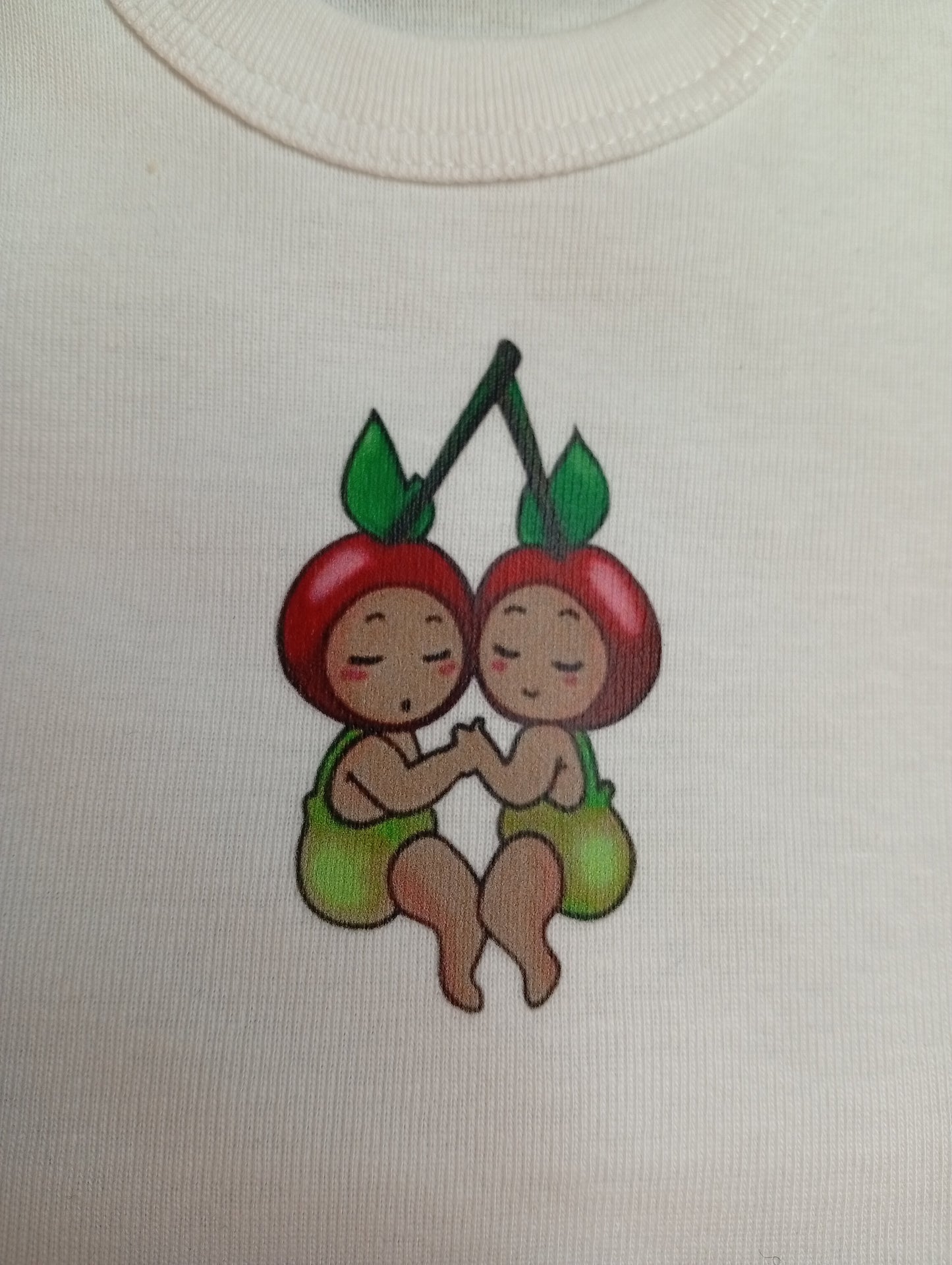 Cute cherry twins cartoon logo on white fabric, baby clothing design