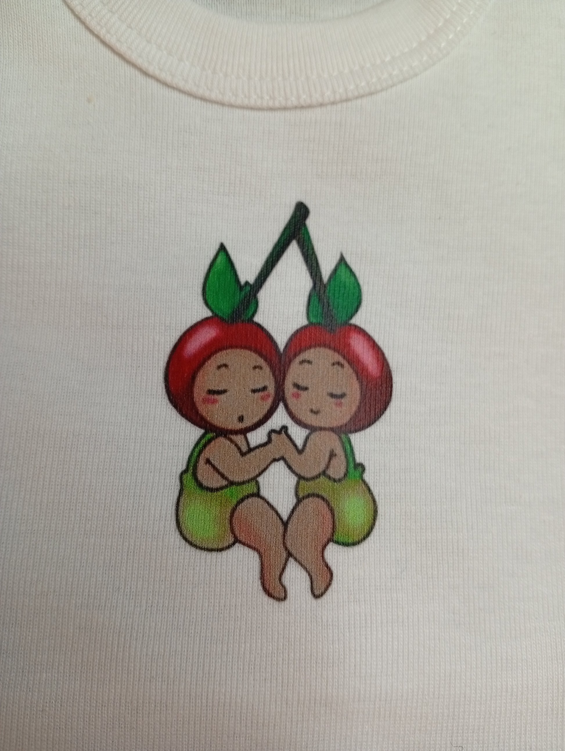 Cute cherry twins cartoon logo on white fabric, baby clothing design