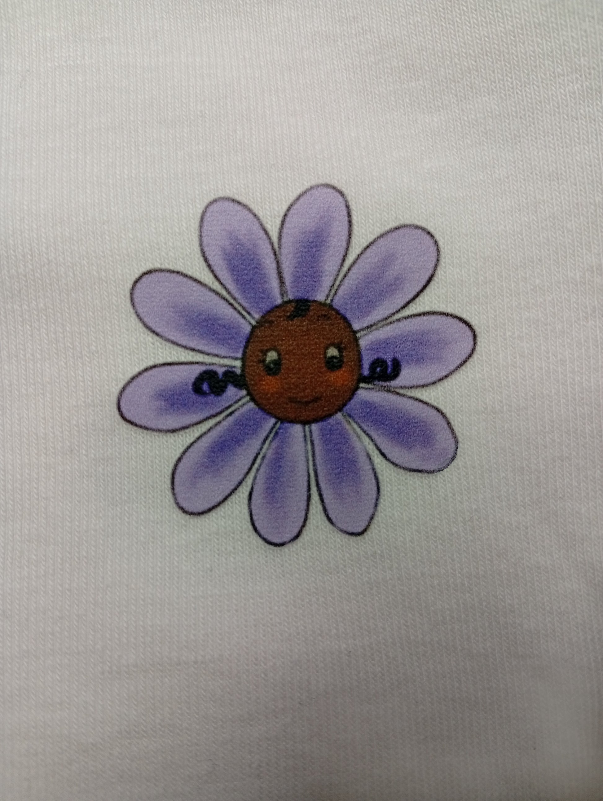Cute purple daisy flower with a smiling face on white fabric background