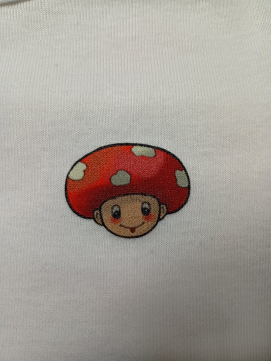 Cartoon mushroom head character with red cap on white fabric background